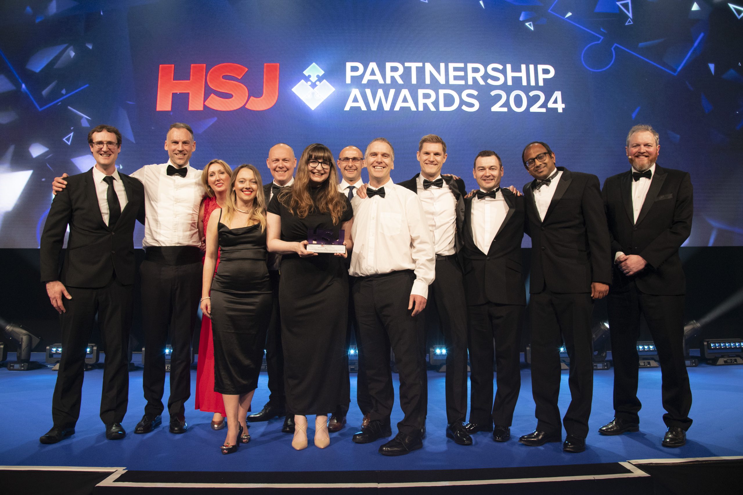 A photograph of the Flippin' Pain team winning a HSJ award