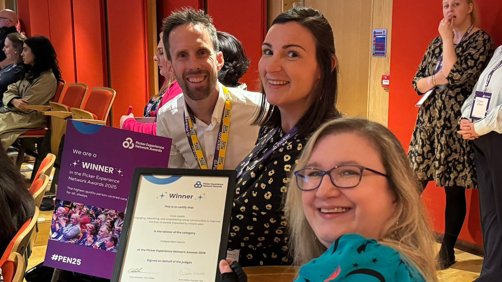 A photograph of the Flippin' Pain team holding an award