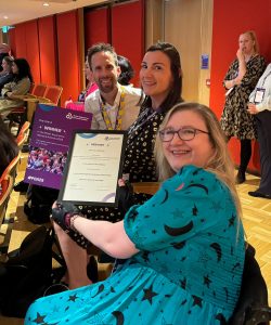 A photograph of the Flippin' Pain team holding an award