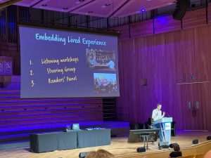 A photograph of team member Shep presenting