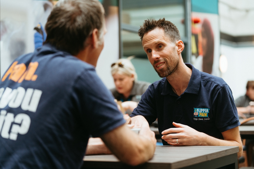 A photograph of Chris Shepherdson speaking to someone